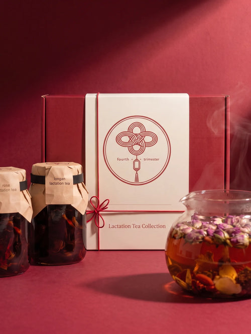 The Lactation Tea Collection box with rose and longan tea jars and a glass teapot of freshly brewed tea